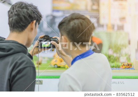 People testing professional photography cameras at.Trade show on photography equipment. Selective focus on camera. 83562512