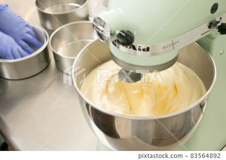 Material image of the process of whipping dough with a candy making stand mixer Material image of the process of whipping dough with a candy making stand mixer 83564892