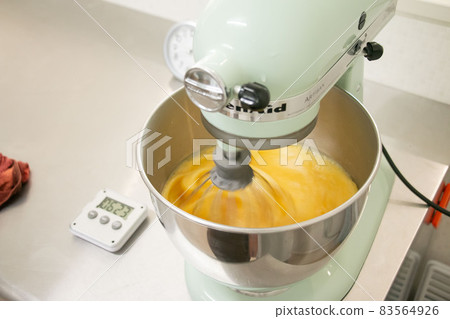 Material image of the process of whipping dough with a candy making stand mixer 83564926
