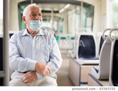 Old man wearing face mask in streetcar Old man wearing face mask in streetcar 83565550
