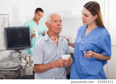 Sonographer talking with patient before procedure Sonographer talking with patient before procedure 83565551