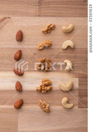 Nuts lined up on a wooden table Nuts lined up on a wooden table 83565619