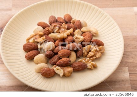 Mixed nuts walnut material and nuts placed on a wooden table Mixed nuts walnut material and nuts placed on a wooden table 83566046