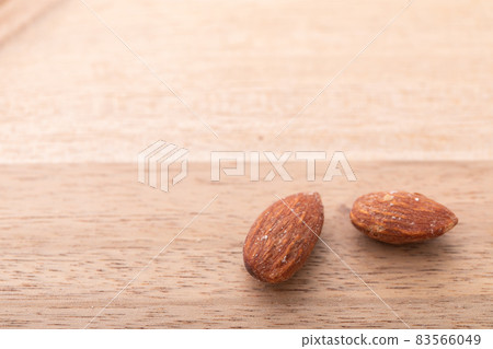Almond walnut material and nuts placed on a wooden table Almond walnut material and nuts placed on a wooden table 83566049