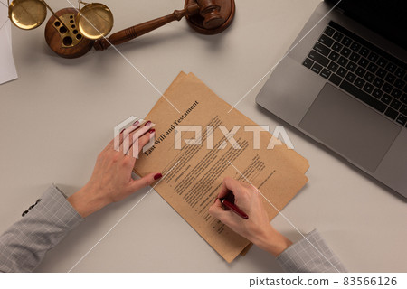 Woman signing papers at the office Woman signing papers at the office 83566126