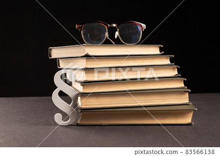 sign paragraph glasses and books on black stone background sign paragraph glasses and books on black stone background 83566138