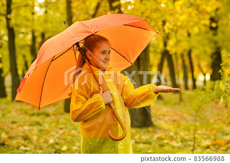 girl with an umbrella and rubber boots on an autumn walk girl with an umbrella and rubber boots on an autumn walk 83566988