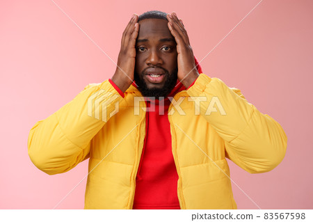 Shocked upset african-american bearded guy feel regret stunned hear terrible news hold hands head widen eyes stupor standing speechless troubled, look perplexed terribly sad, pink background 83567598