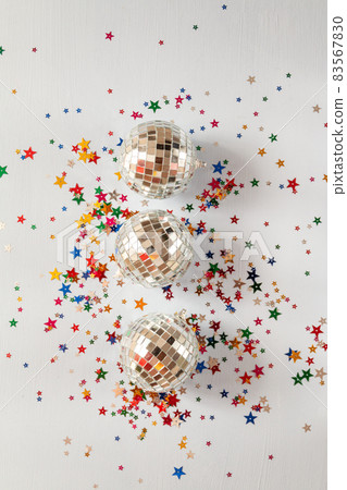 Disco ball on blue background with multicolored stars confetti Disco ball on blue background with multicolored stars confetti 83567830