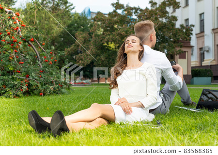 young woman in the park on the grass 83568385