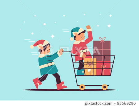 elves preparing for new year and christmas holidays celebration santa helpers pushing trolley cart with gifts elves preparing for new year and christmas holidays celebration santa helpers pushing trolley cart with gifts 83569290