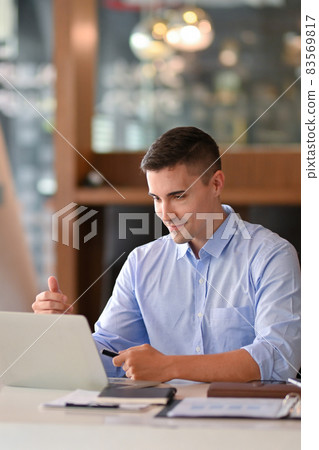 Businessman working on laptop computer in his modern office room. Businessman working on laptop computer in his modern office room. 83569817