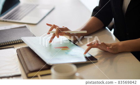 Businesswoman using tablet, fingers tapping, touching on a modern digital tablet screen 83569842