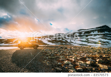 Aurlandsfjellet, Norway. Car SUV Parked Near Aurlandsfjellet Scenic Route Road In Summer Norwegian Landscape. Popular Destination In Sunset Lights. Sunshine Aurlandsfjellet, Norway. Car SUV Parked Near Aurlandsfjellet Scenic Route Road In Summer Norwegian Landscape. Popular Destination In Sunset Lights. Sunshine 83570573