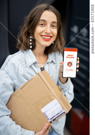 Girl with parcel and phone with smart delivery app Girl with parcel and phone with smart delivery app 83571808