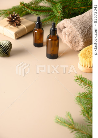 Christmas Spa concept with gift, wellness objects, cosmetic oil for relax. 83572043