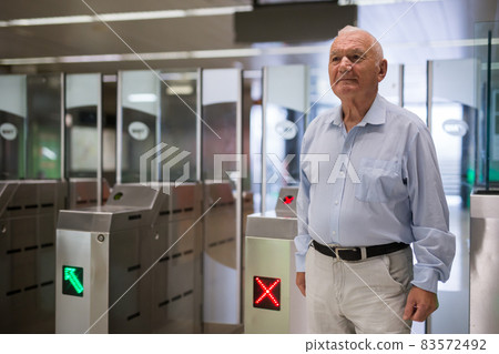 Old man entering subway station Old man entering subway station 83572492
