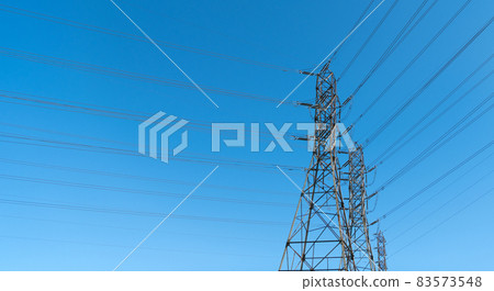 electrical power lines of pylon producing energy on electric tower on blue sky background, power. electrical power lines of pylon producing energy on electric tower on blue sky background, power. 83573548