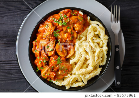 spaetzle with mushroom gravy in a black bowl spaetzle with mushroom gravy in a black bowl 83573961