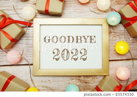 Goodbye 2022 typography text with LED cotton ball on wooden background Goodbye 2022 typography text with LED cotton ball on wooden background 83574330