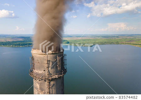Aerial view of coal power plant high pipes with black smokestack polluting atmosphere. Electricity production with fossil fuel concept. Aerial view of coal power plant high pipes with black smokestack polluting atmosphere. Electricity production with fossil fuel concept. 83574482