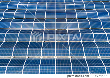 Aerial view of solar power plant with blue photovoltaic panels mounted on industrial building roof for producing green ecological electricity. Production of sustainable energy concept. 83574566