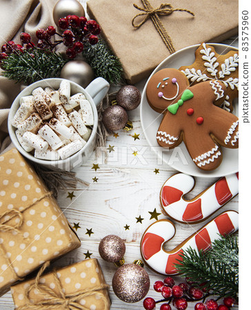 Christmas background with gift box, cocoa and gingerbread cookies. Christmas background with gift box, cocoa and gingerbread cookies. 83575960