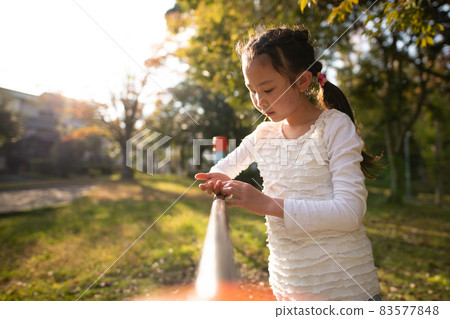 Girl playing in the autumn park 83577848