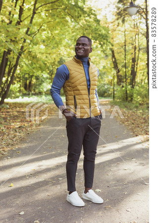 Hipster african american man walking in autumn park Hipster african american man walking in autumn park 83578289