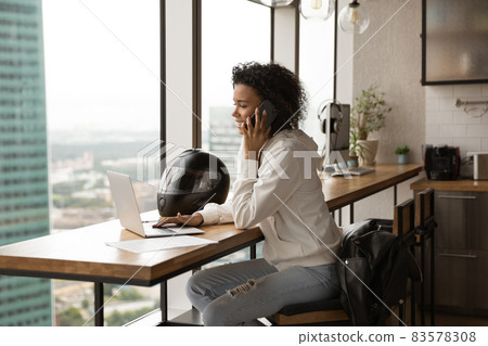 Busy happy young african american businesswoman multitasking in modern office. Busy happy young african american businesswoman multitasking in modern office. 83578308