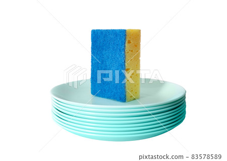 Dishwashing sponge is on a stack of saucers, small plates. Clean dishes concept. Isolated. White background. Dishwashing sponge is on a stack of saucers, small plates. Clean dishes concept. Isolated. White background. 83578589