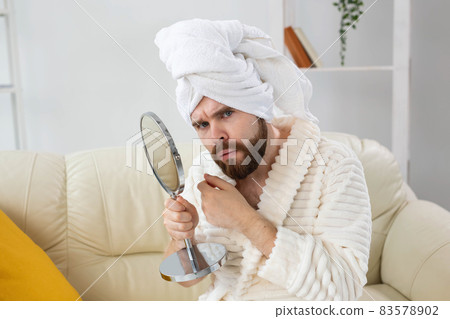 Bearded man checking his skin of face. Spa, body and skin care for male concept. Bearded man checking his skin of face. Spa, body and skin care for male concept. 83578902