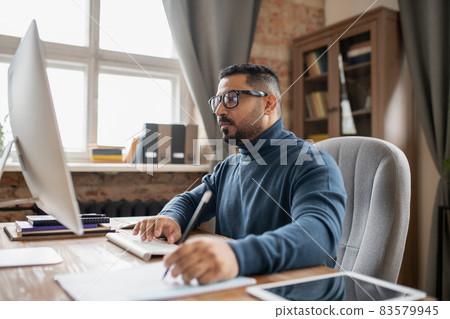 Serious mature man pressing key and looking at computer screen 83579945