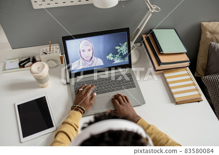 Young confident teacher on laptop screen looking at student 83580084