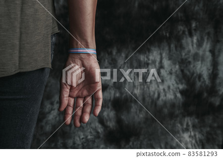 is wearing a transgender pride wristband 83581293