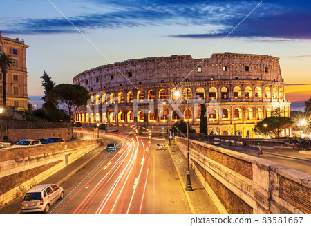 Beautiful view on Colosseum and a road nearby at sunset, Rome, Italy 83581667