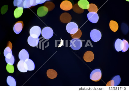 Crescent moon floating in bright illuminations Crescent moon floating in bright illuminations 83581740