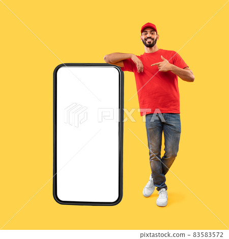 Arabic Courier Guy Leaning On Big Phone, Yellow Background, Mockup 83583572