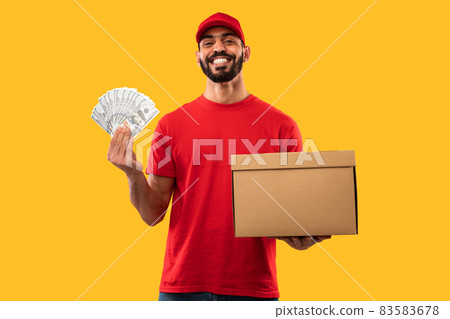Arabic Courier Guy Holding Money And Parcel Box, Yellow Background Arabic Courier Guy Holding Money And Parcel Box, Yellow Background 83583678