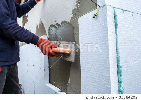 Insulation of facade wall with styrofoam sheets. Polystyrene insulation  boards with glue adhesive Stock Photo by bilanol