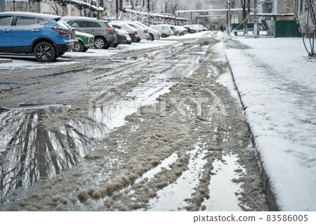 Slush on the road during winter snowfall 83586005