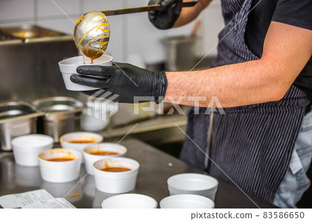 Chef preparing takeaway dish in the restaurant or pub , food delivery concept, home delivery, online order Chef preparing takeaway dish in the restaurant or pub , food delivery concept, home delivery, online order 83586650