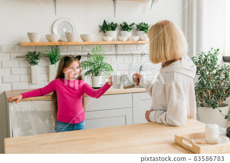 Grandmother and granddaughter having fun together at home. Generation and family concept Grandmother and granddaughter having fun together at home. Generation and family concept 83586783