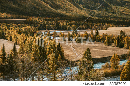 Car traces on the bank of the winding river 83587091