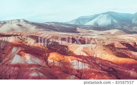 Red mountains of Altai regions. Blue peaks in the background. Red mountains of Altai regions. Blue peaks in the background. 83587557