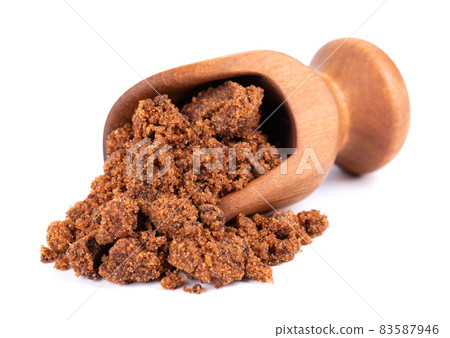 Muscovado sugar in wooden scoop, isolated on white background. Barbados sugar, khandsari or khand. Muscovado sugar in wooden scoop, isolated on white background. Barbados sugar, khandsari or khand. 83587946