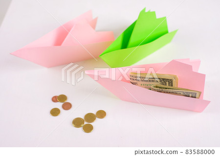 Business concept, 3-paper boats floating nearby and money on Board, a few coins ahead Business concept, 3-paper boats floating nearby and money on Board, a few coins ahead 83588000