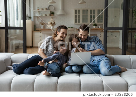 Happy young parents and adorable little children using computer. Happy young parents and adorable little children using computer. 83588206
