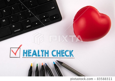Health Check. Red rubber heart and black computer keyboard on a white background 83588311