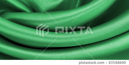 Smooth elegant green silk or satin luxury cloth texture as abstract background. Luxurious background design 83588600
